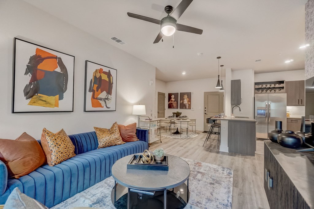 a living room with a blue couch and a coffee table
