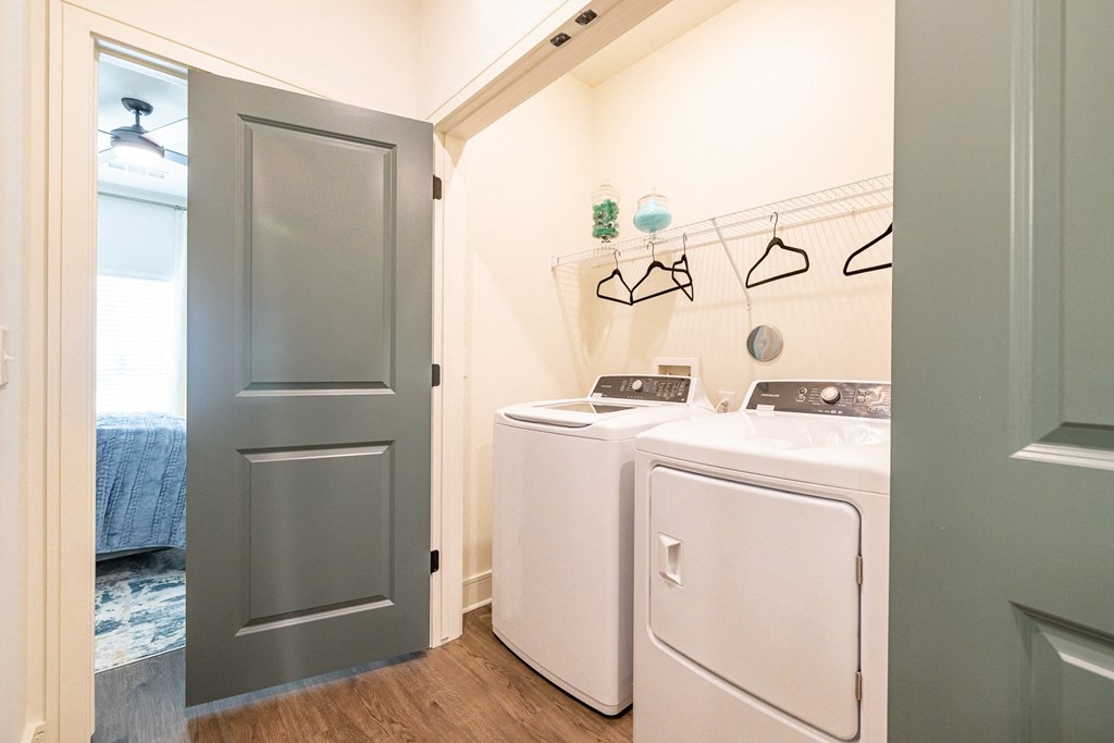 a washer and dryer in a laundry room with a blue door