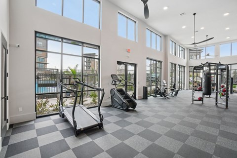 A spacious gym with treadmills, elliptical machines, and other exercise equipment.