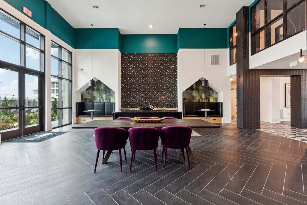 a dining room with purple chairs and a table