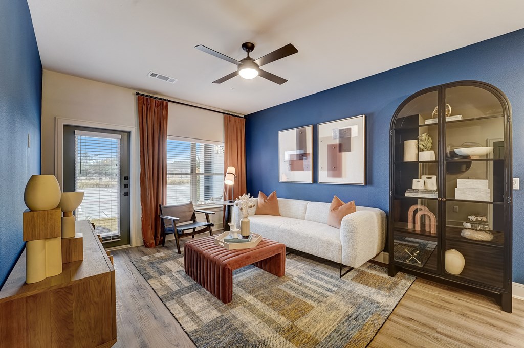 a living room with a blue accent wall and a white couch