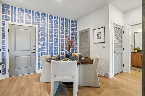 A dining room with a table set for two.
