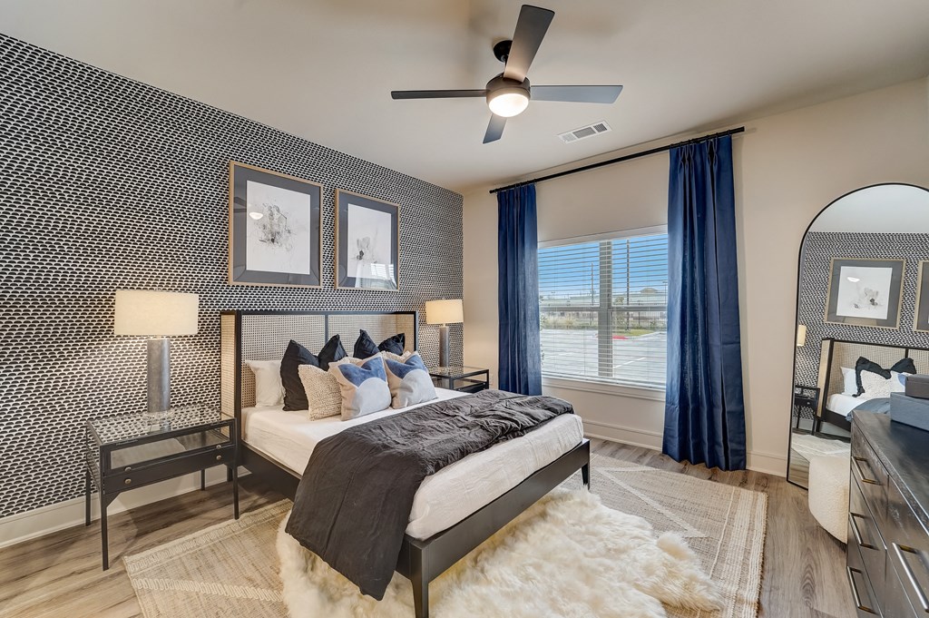a bedroom with a large bed and a ceiling fan