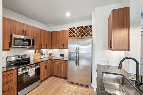 A kitchen with wooden cabinets and stainless steel appliances.