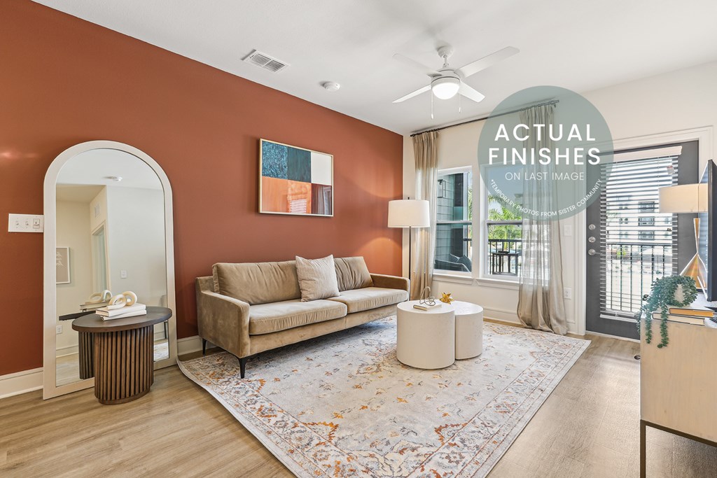 Living room with a couch, coffee table, and rug.