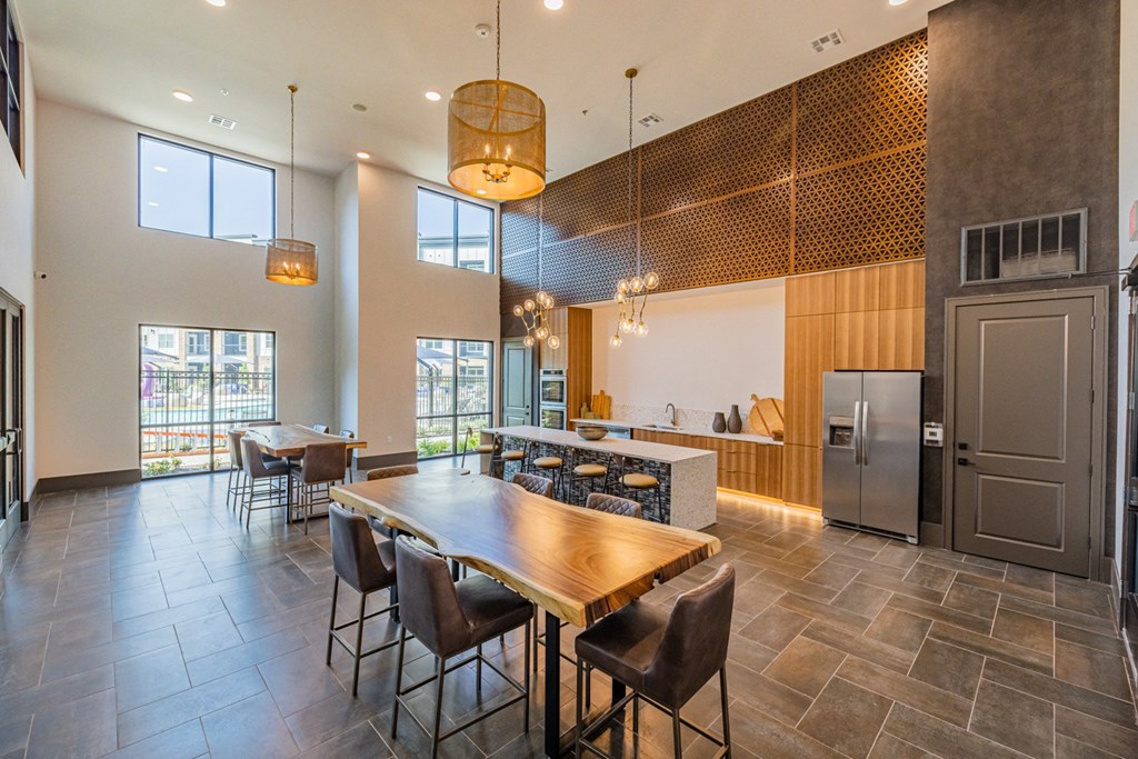 a large kitchen with a wooden table and chairs