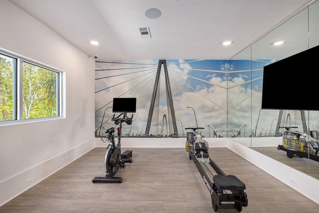 a workout room with weights and a mural of the golden gate bridge