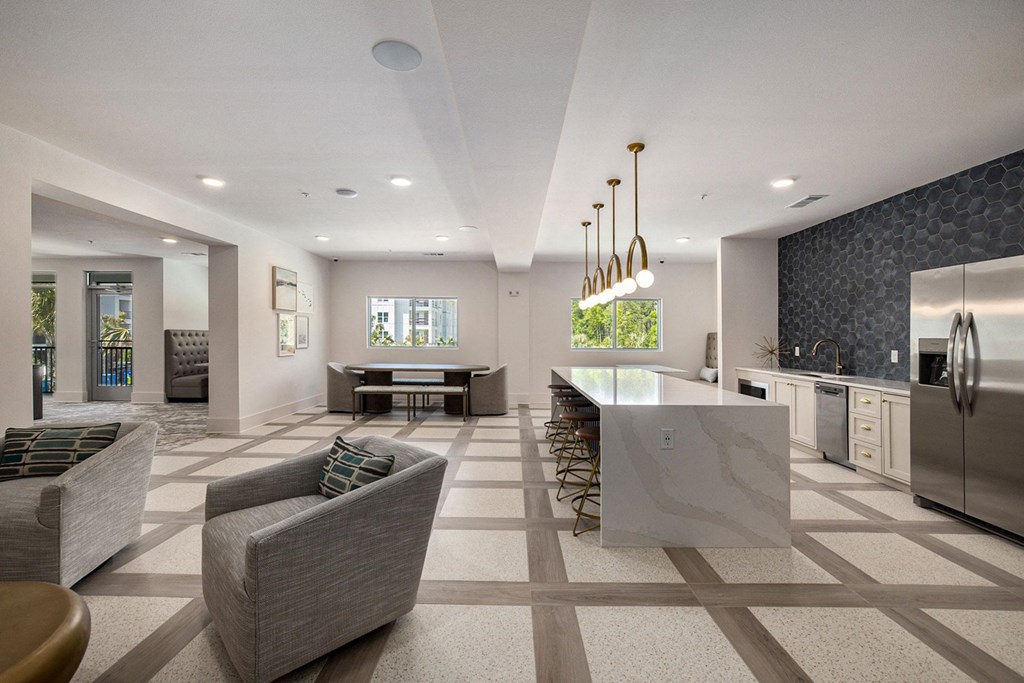 a large kitchen and living room with a table and chairs