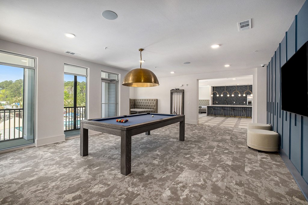 a game room with a pool table and a bar