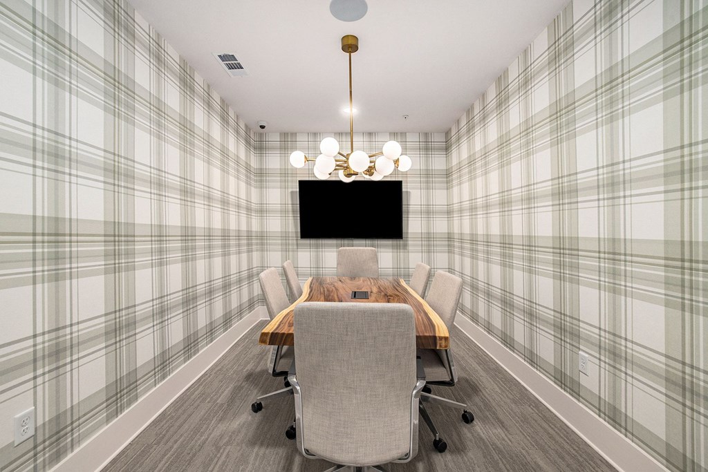 a conference room with a table and chairs