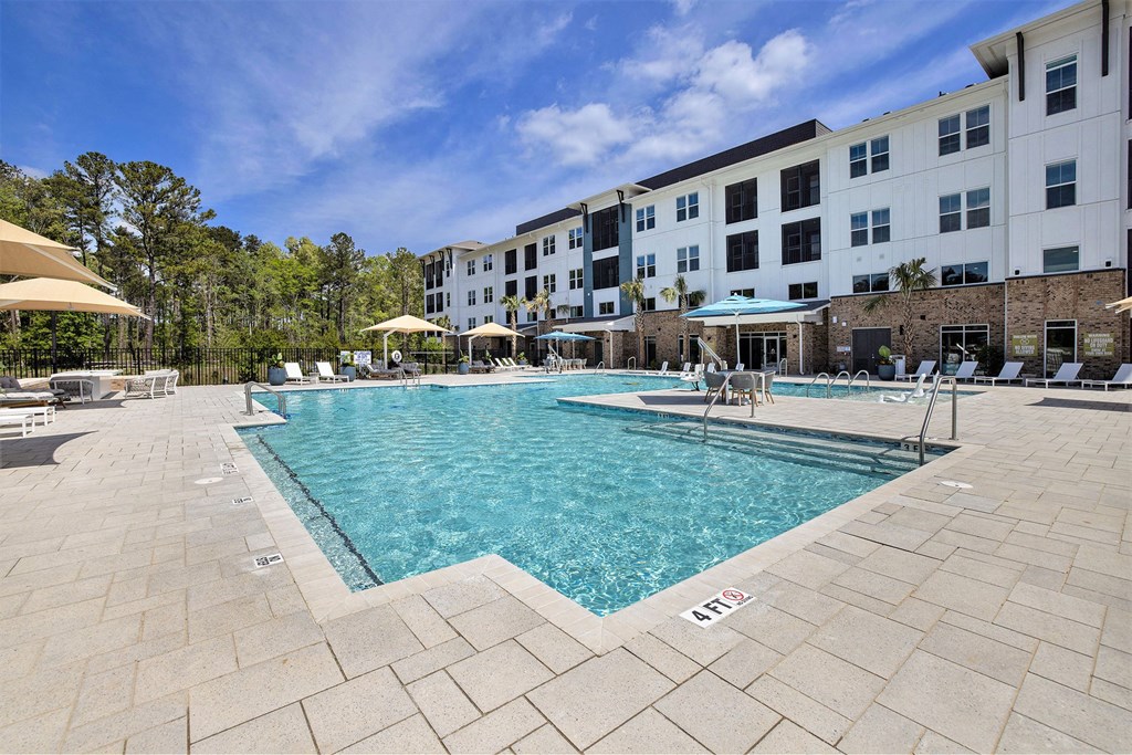 a swimming pool with a building in the background