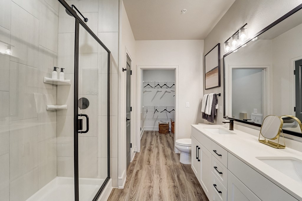 a bathroom with a shower and a sink and a mirror