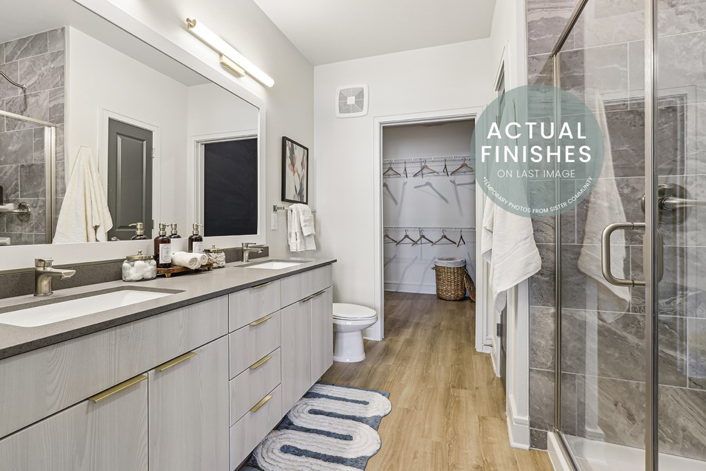 A bathroom with a toilet, sink, and shower.