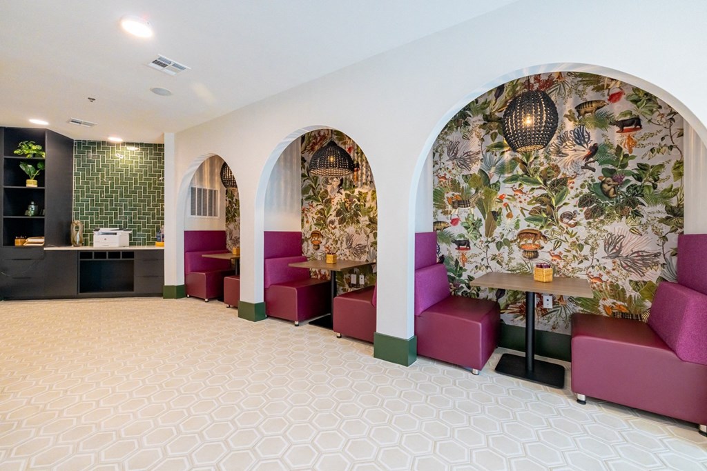 a lobby with purple chairs and a large wall mural