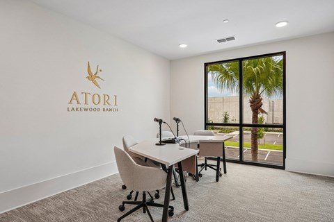 A room with a desk and chairs and a logo that says Atori Lakewood Ranch.