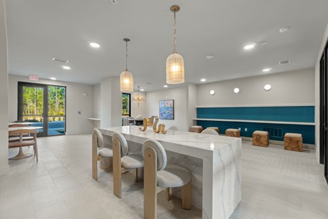 A modern dining room with a long table and chairs.