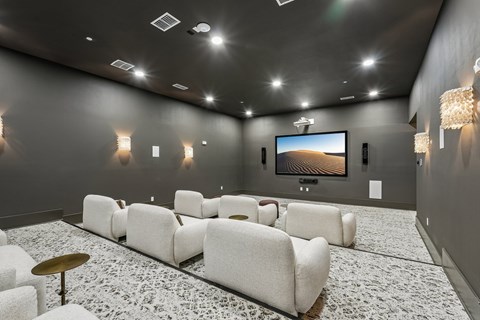 A home theater with a large screen and comfortable seating.
