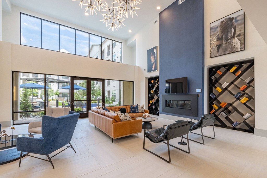 a living room with a couch and chairs and a fireplace
