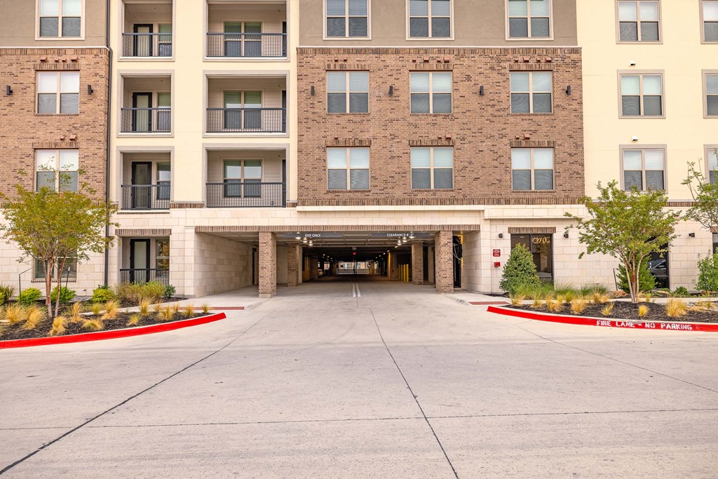 an empty parking lot in front of an apartment building