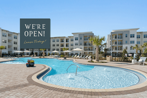 A pool area with a sign that says "We're Open! Love Tidbits!"