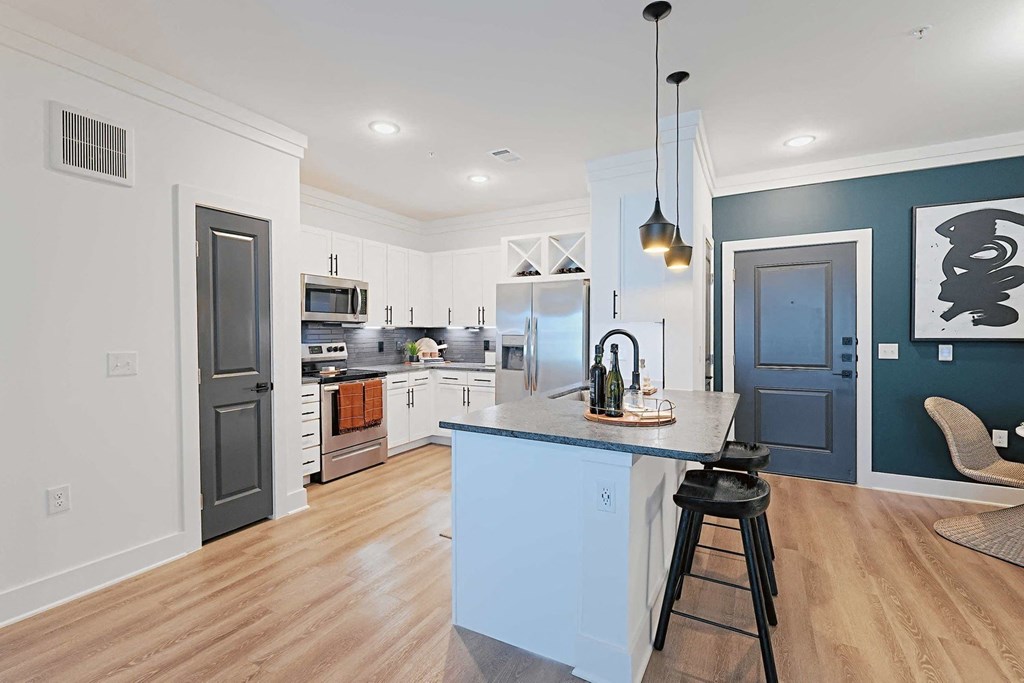 a kitchen with a blue island and white cabinets