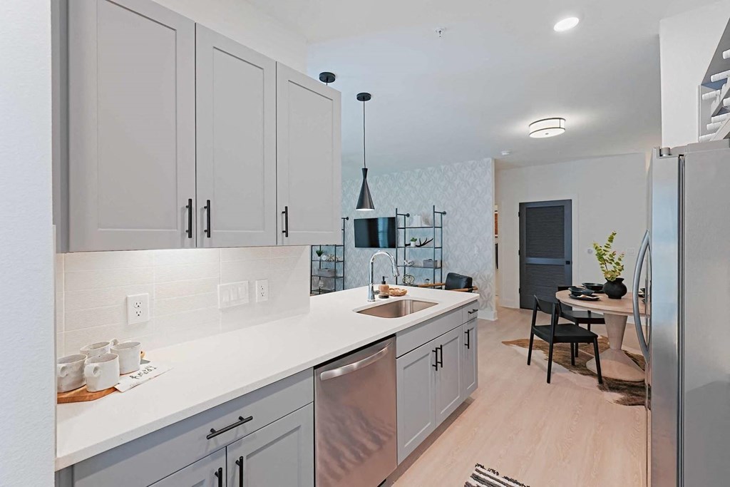 an open kitchen with white cabinets and a sink
