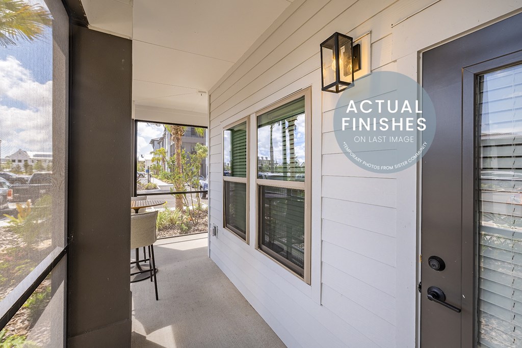 A balcony with a chair and a window.