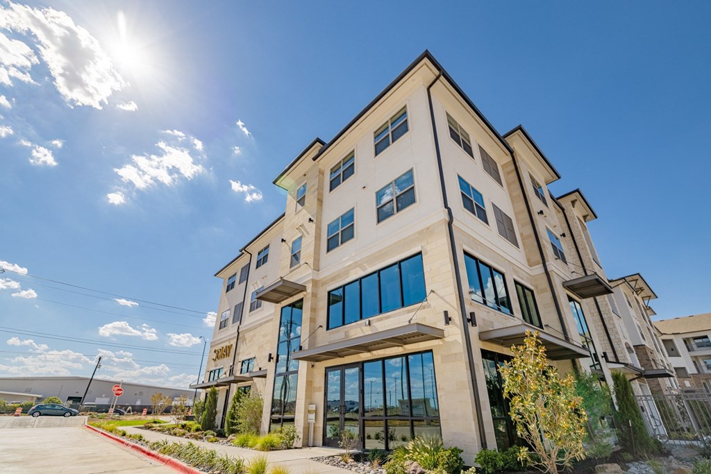 a large building with the sun shining in front of it