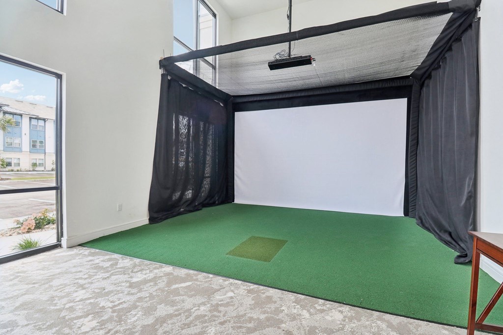 a room with a green carpet and a black curtain