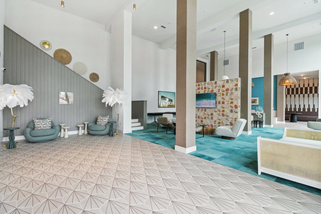 a lobby with couches and chairs and a rug