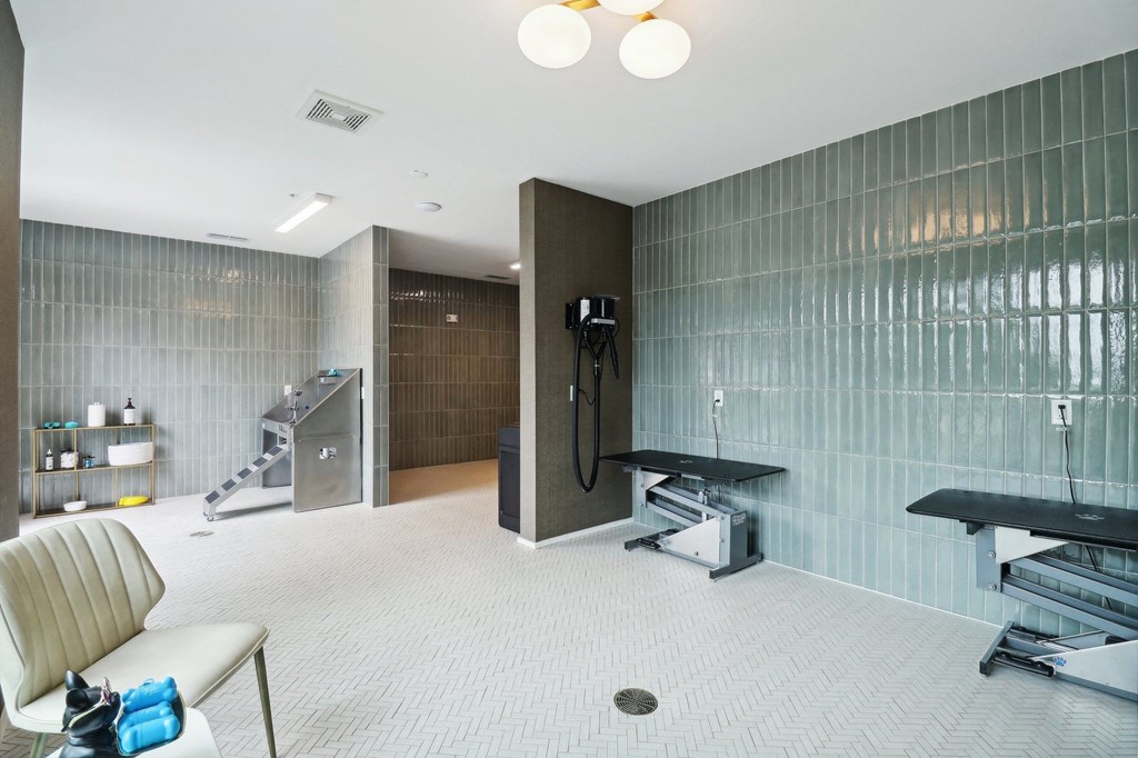a gym with a shower and a chair in a room