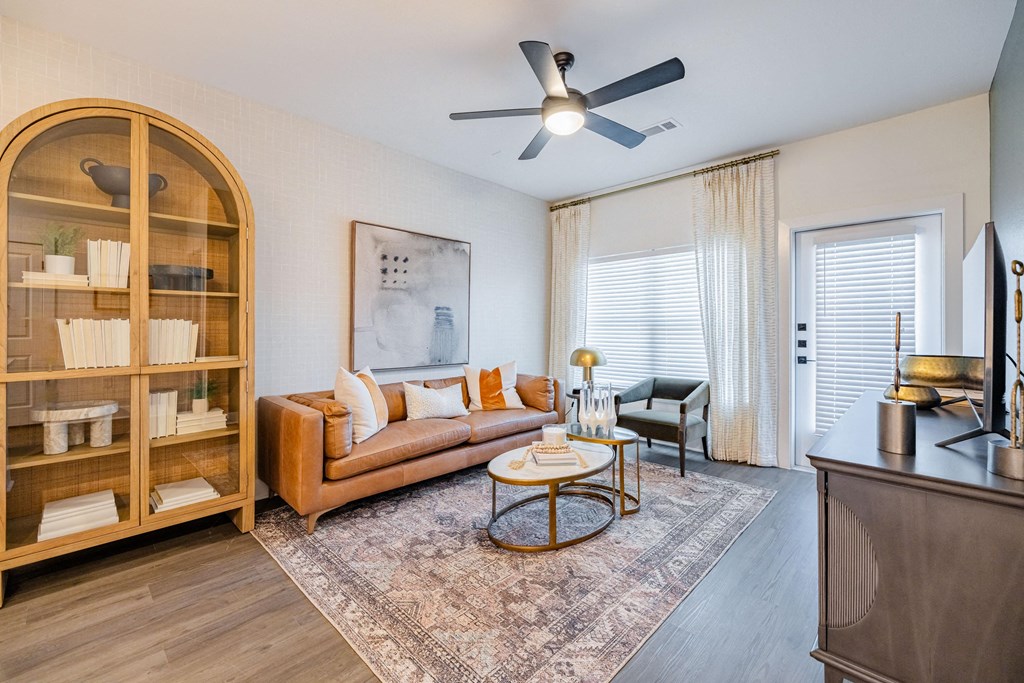 a living room with a couch and a ceiling fan