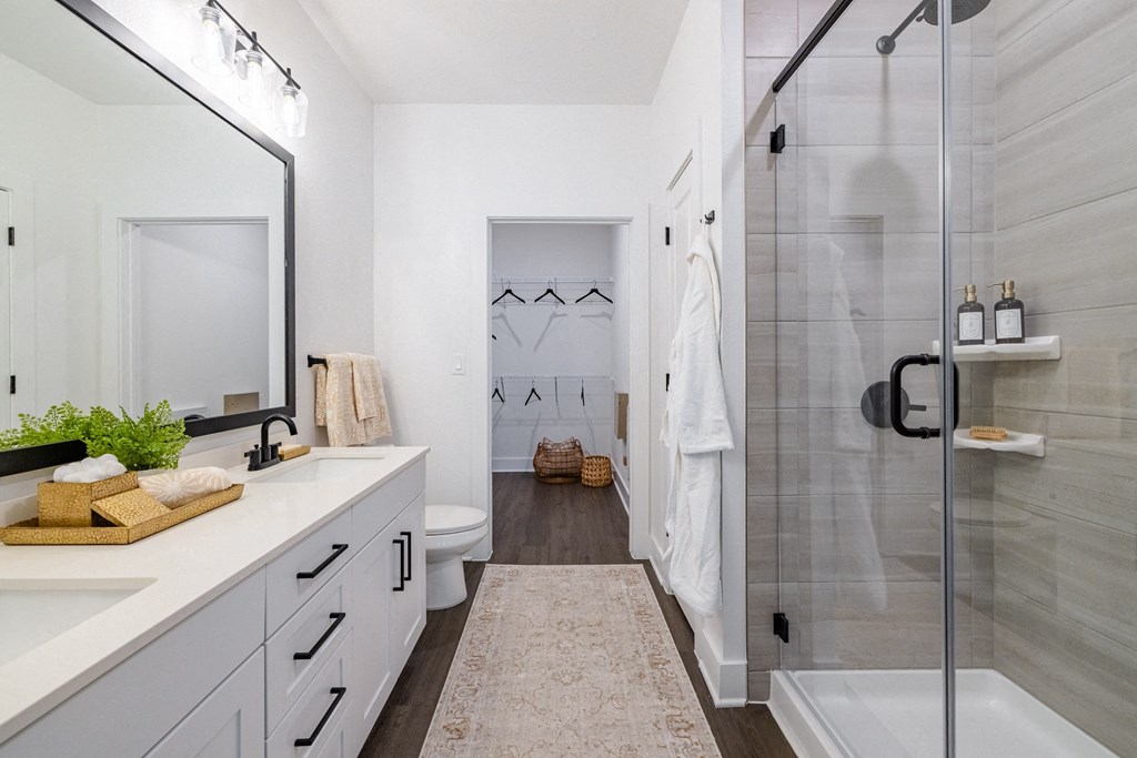 a bathroom with a shower and a sink and a mirror