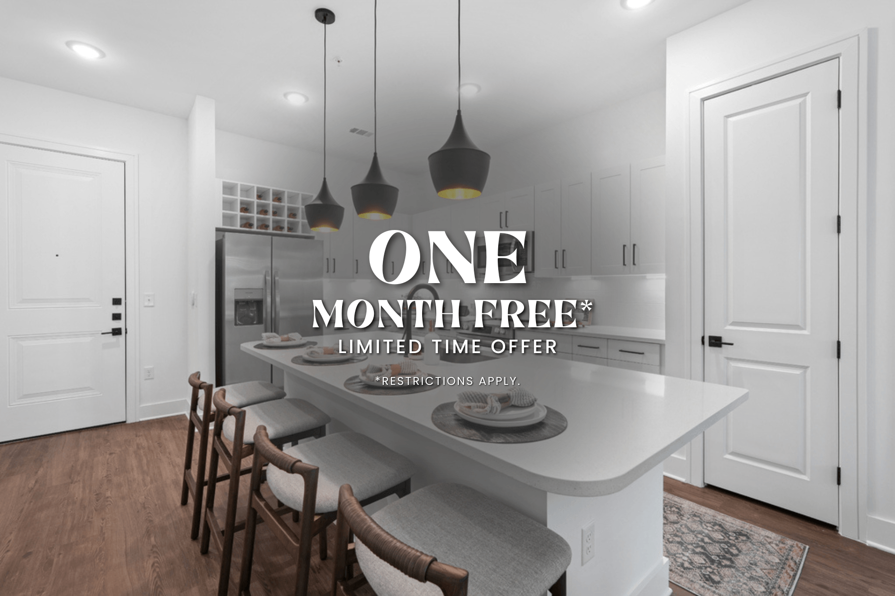 A kitchen with a white countertop and a sign that says "ONE MONTH FREE* LIMITED TIME OFFER *RESTRICTIONS APPLY".