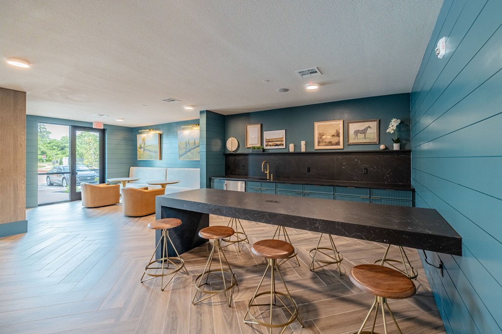 a kitchen with a long counter and stools