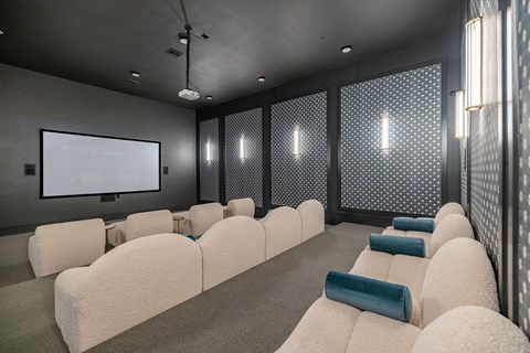 A modern home theater with a large screen and comfortable seating.