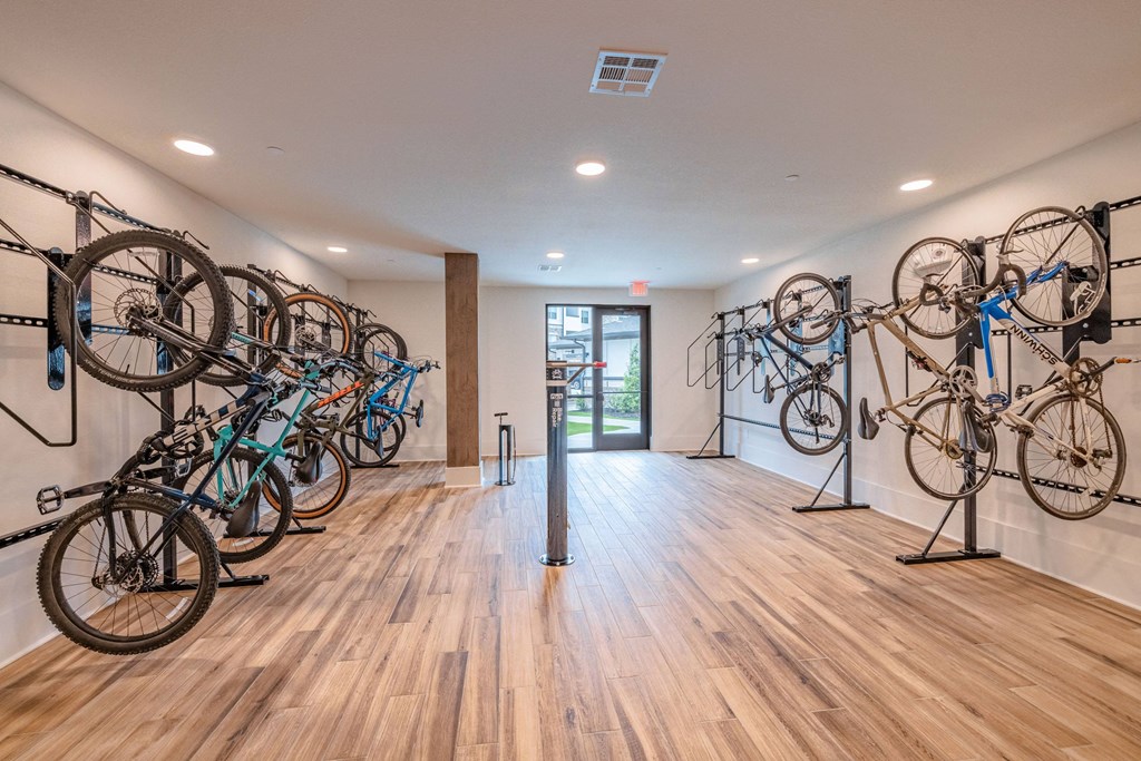 a group of bikes hanging on a wall in a room