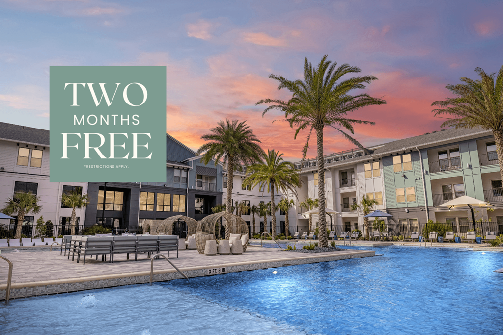 a swimming pool with palm trees in front of an apartment building