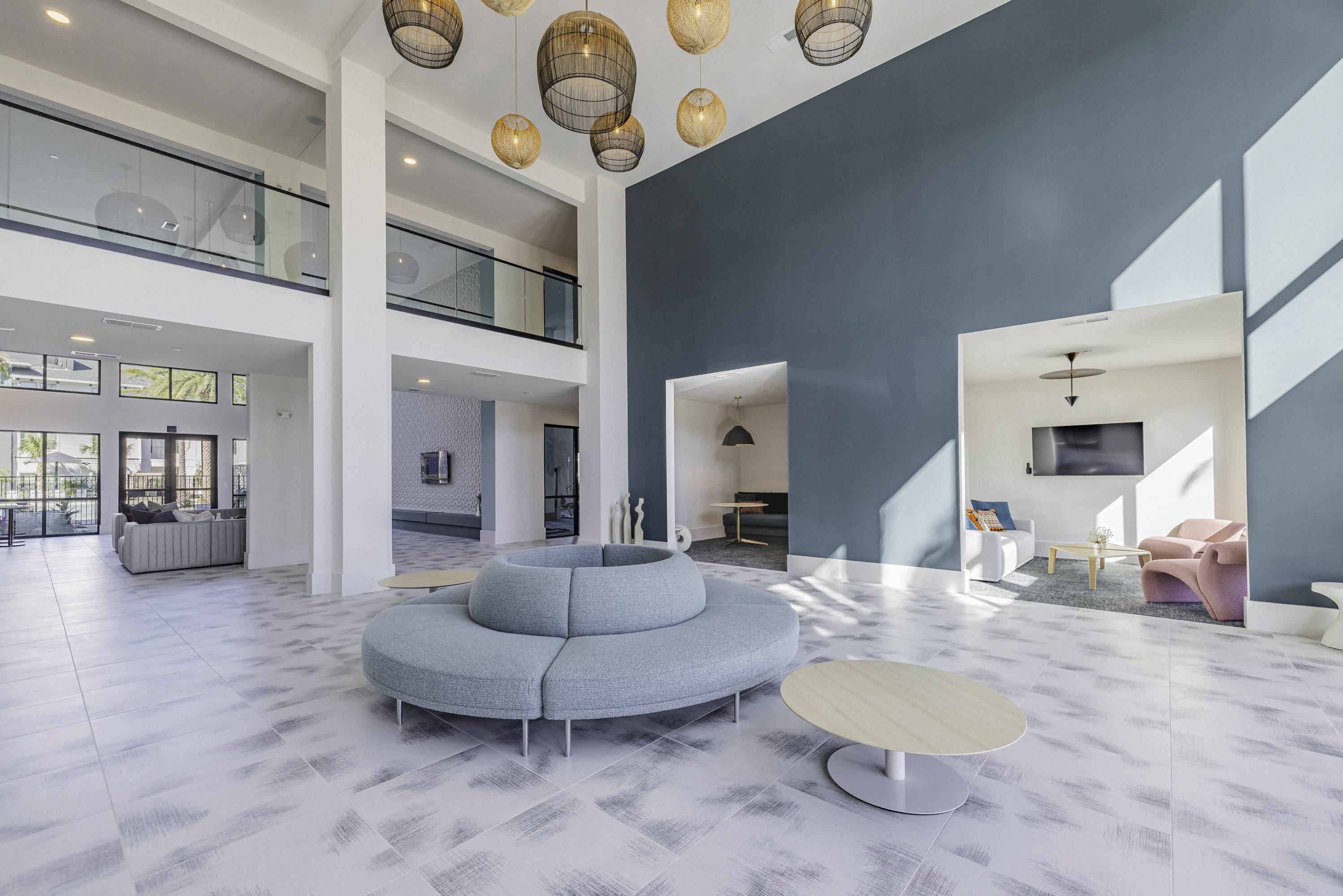 a living room with a blue couch and a round table