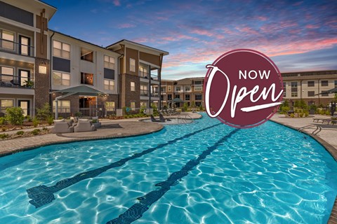 a swimming pool with a now open sign in front of an apartment building