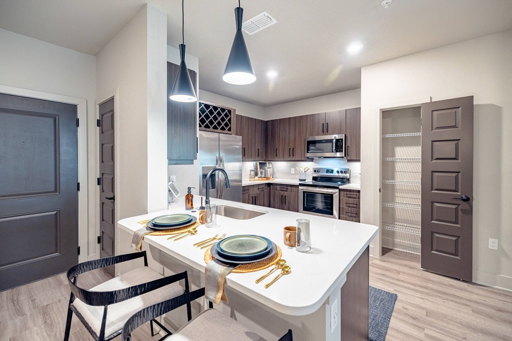 the residence apartment homes offers a large kitchen with white counter tops and