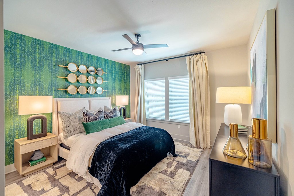 a bedroom with a bed and a ceiling fan