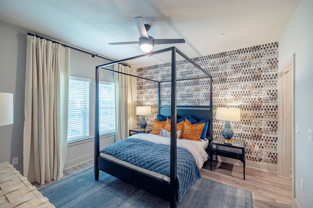 a bedroom with a bed and a ceiling fan