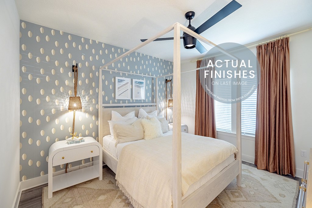 A bedroom with a bed, nightstand, and a wall with circular patterns.