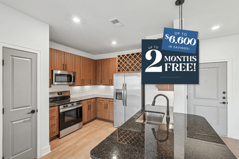 A kitchen with a sign offering up to $6,600 in savings and 2 months free.