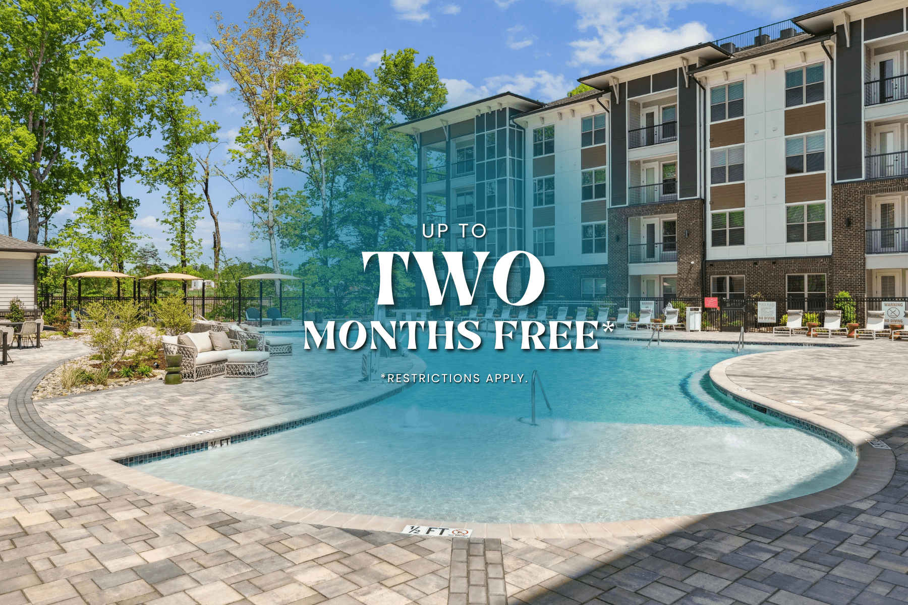 A swimming pool in front of a building with the text "UP TO TWO MONTHS FREE" on it.
