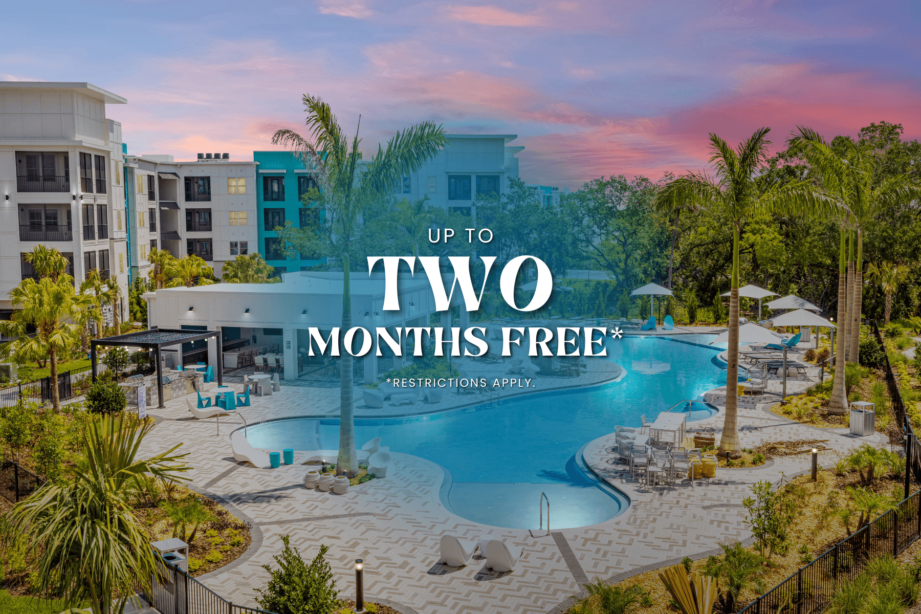 A pool surrounded by palm trees and a building in the background with the text "UP TO TWO MONTHS FREE* RESTRICTIONS APPLY".
