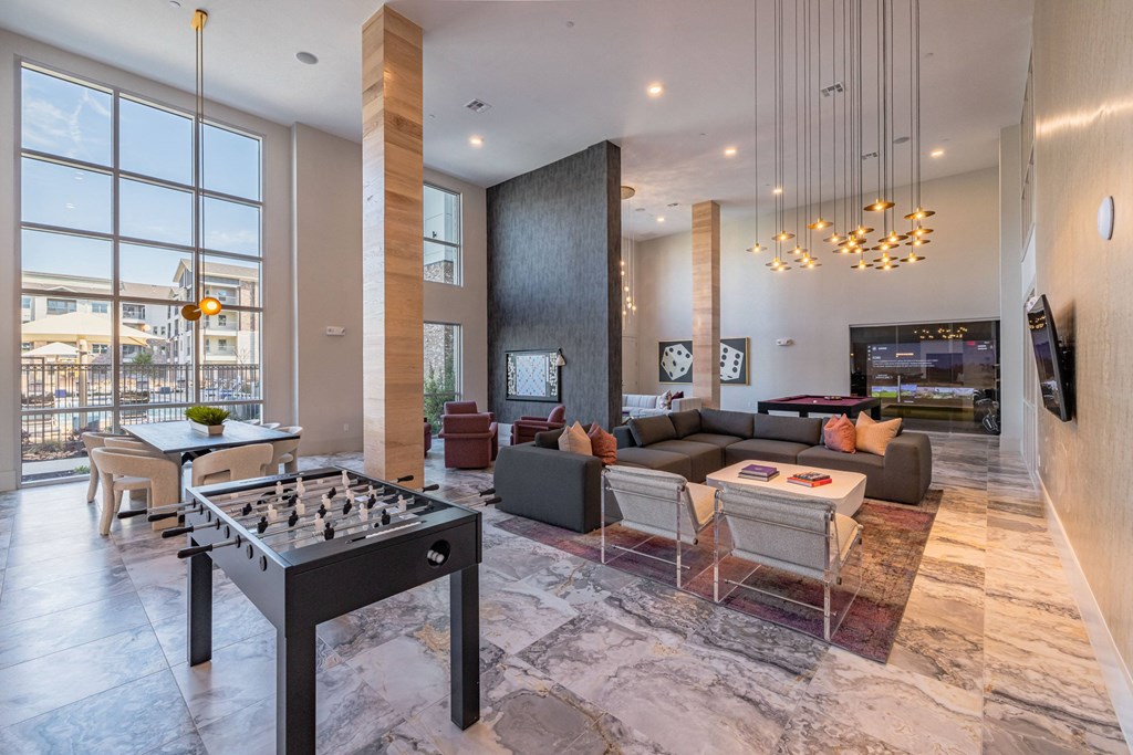 a living room with couches and a table with a chessboard