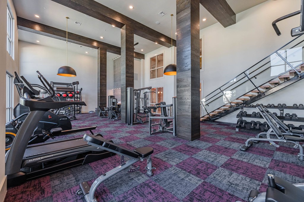 the gym has treadmills and other exercise equipment in the lobby