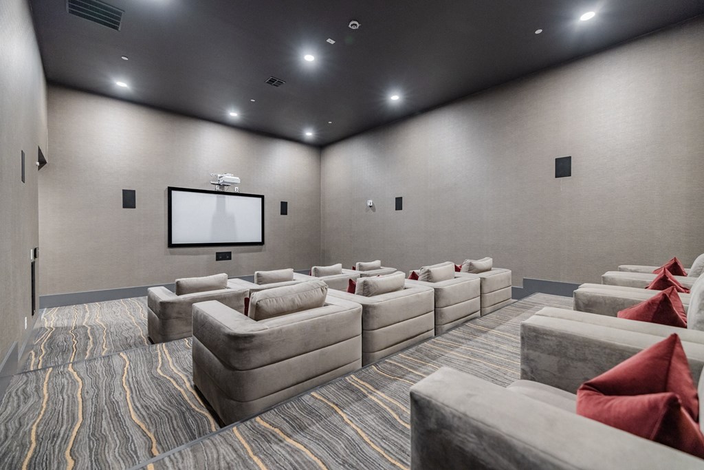 a large screening room with couches and a tv